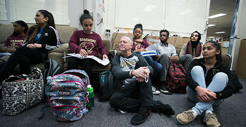 Dr. Martirano sitting with students.