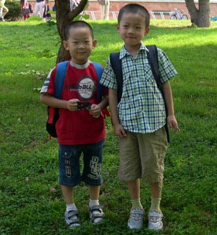 Peter as a toddler standing with Yanjie”